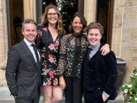 Todd Woodbridge poses with family dressed nicely outdoors
